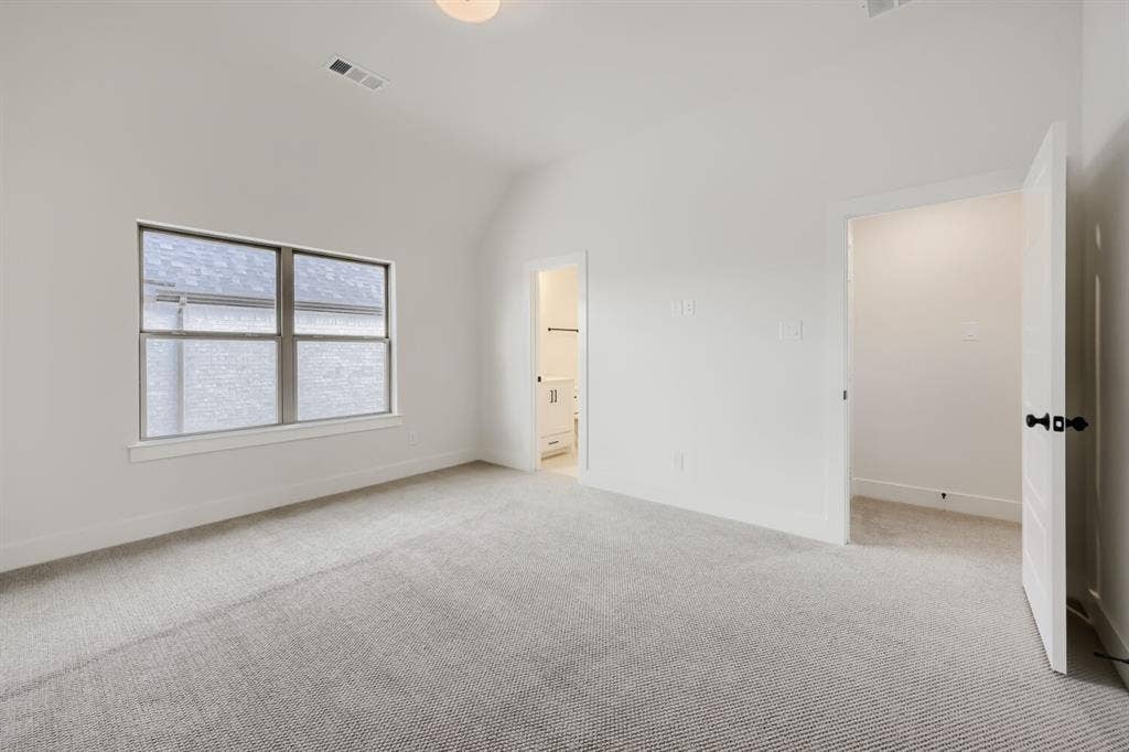 1317 Naples Court, Keller, TX 76248 Vaulted ceiling, light gray carpeting, neutral wall paint, window with white trim, white interior doors with black hardware