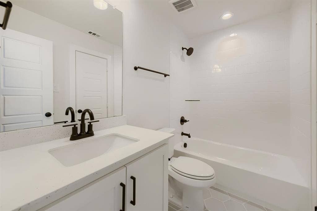 1317 Naples Court, Keller, TX 76248 White vanity with an integrated sink, speckled countertop, and dark-finish faucet