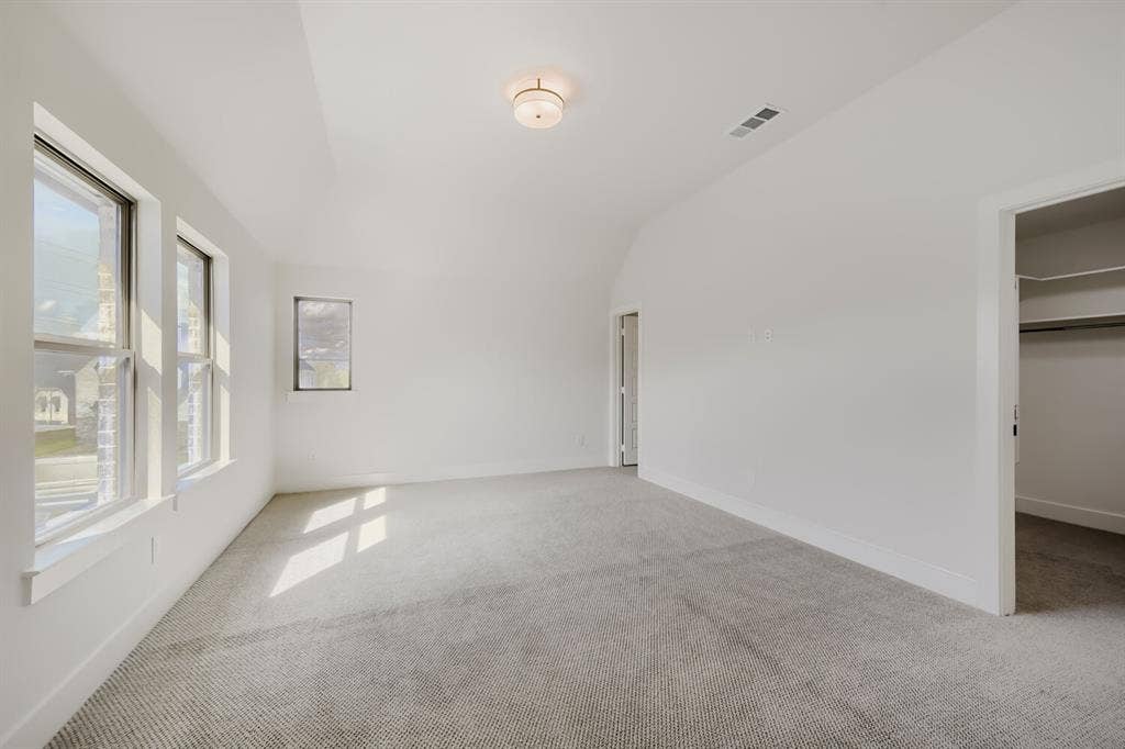 1317 Naples Court, Keller, TX 76248 Vaulted ceiling, recessed lighting, wall-to-wall carpeting, multiple windows, and a built-in closet with shelving