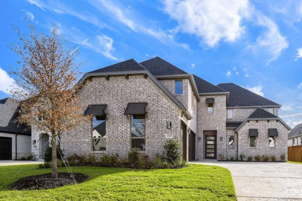 1317 Naples Court, Keller, TX 76248 Brick exterior with dark roof, contemporary front door, multiple dormer windows, and a concrete driveway