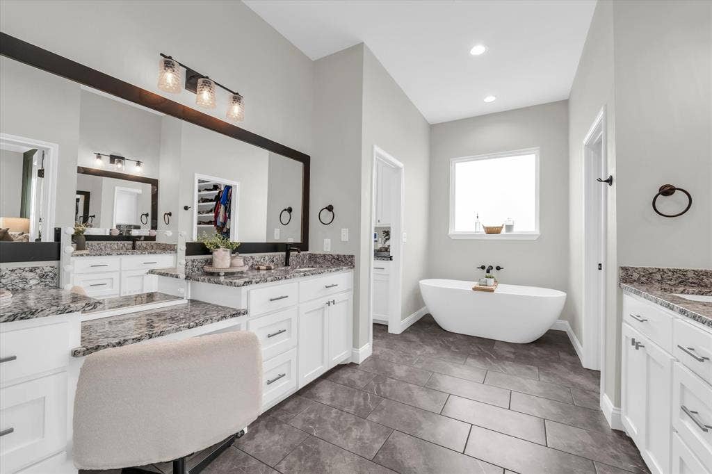 154 Water View Lane, Robinson, TX 76706 primary bathroom with soaking tub, separate vanities, separate tiled shower