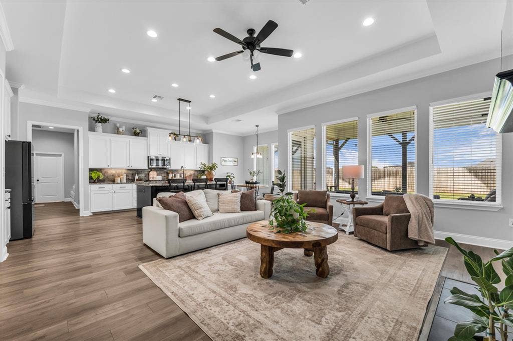 154 Water View Lane, Robinson, TX 76706 living room with built ins and open layout to kitchen and view of covered back porch and backyard