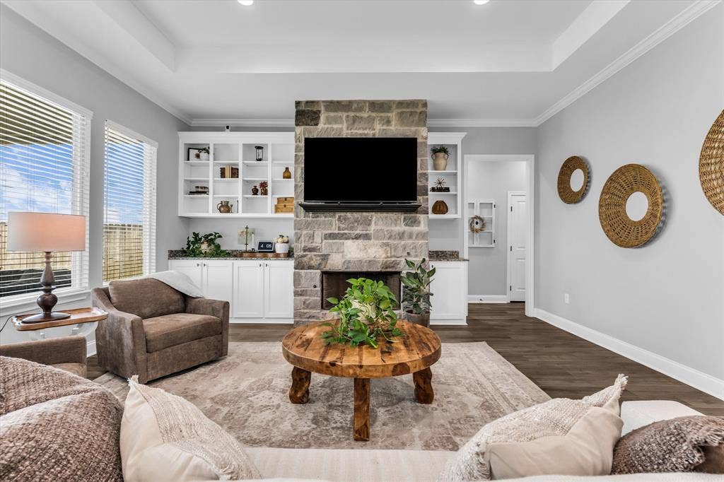 154 Water View Lane, Robinson, TX 76706 stone fireplace in living room with built ins and open layout to kitchen
