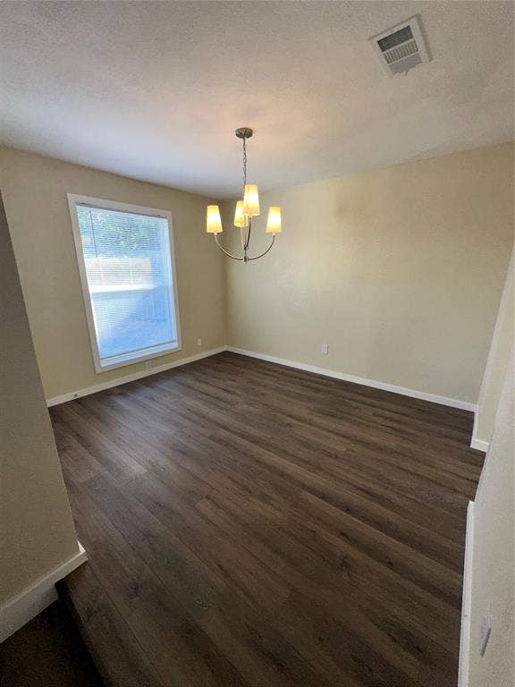 6620 Moss Lane, Watauga, TX 76148 Spacious room featuring wood-finish flooring, a contemporary chandelier, baseboards, and a large window with blinds