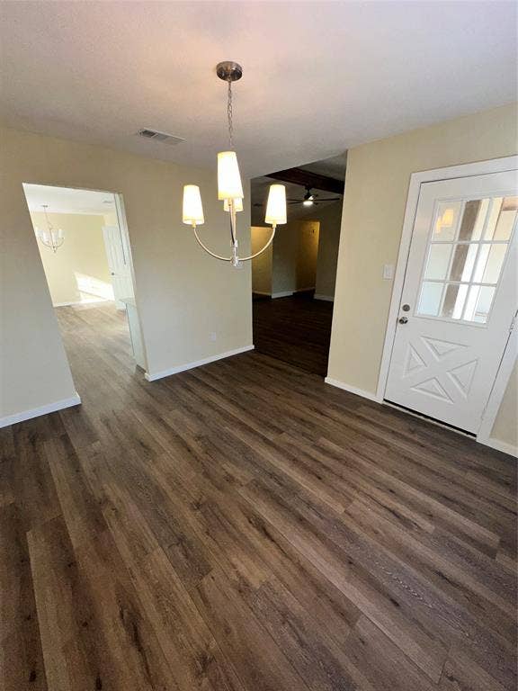 6620 Moss Lane, Watauga, TX 76148 Open concept interior featuring wide plank wood-finish flooring, a contemporary chandelier, and a paneled entry door with glass inserts