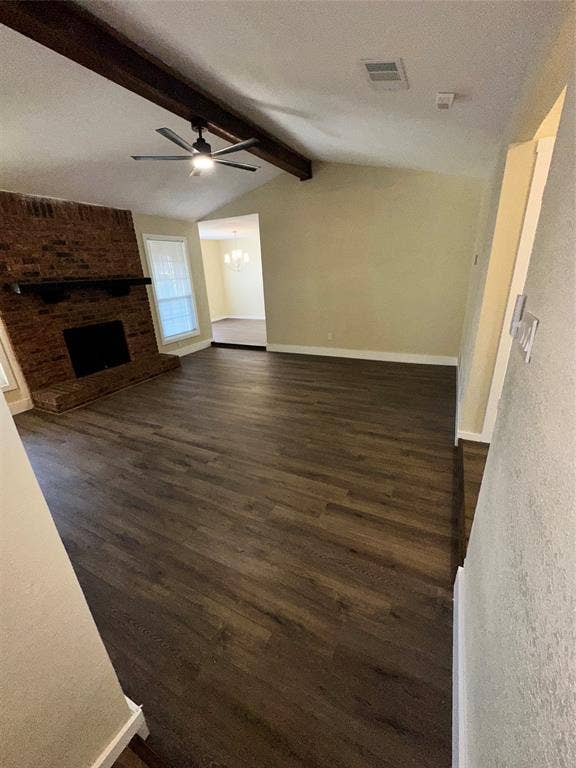 6620 Moss Lane, Watauga, TX 76148 Spacious living area featuring wood-finish flooring, a vaulted ceiling with exposed beam, and a ceiling fan