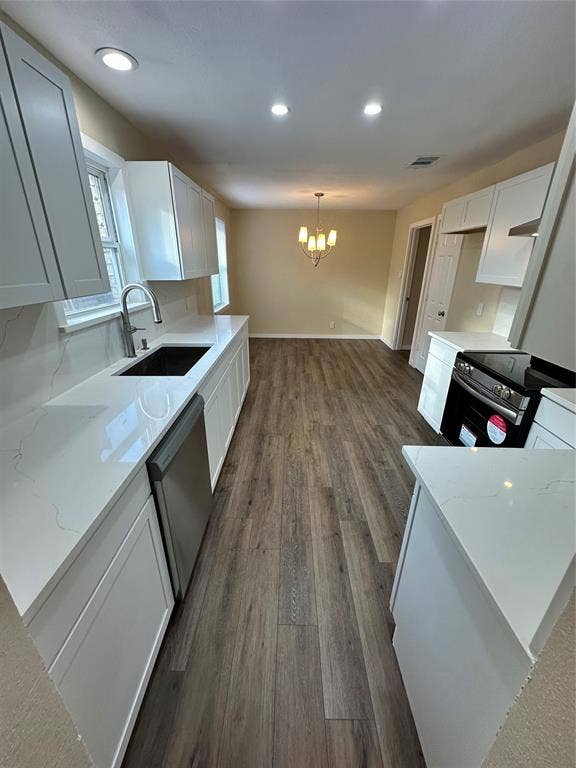 6620 Moss Lane, Watauga, TX 76148 Contemporary kitchen featuring white cabinetry, light-toned countertops, a stainless steel dishwasher, and wood-finish flooring