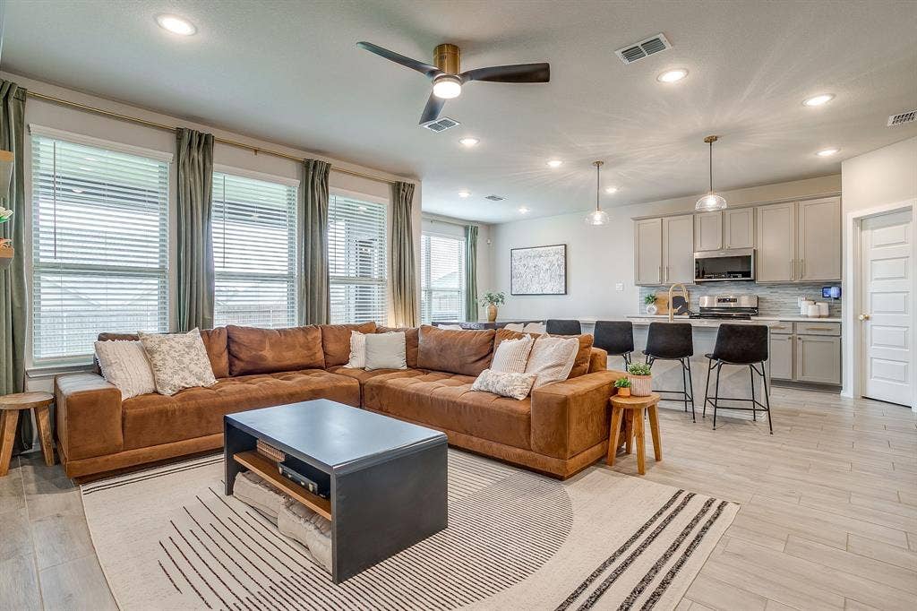 14124 Cassiopeia Drive, Haslet, TX 76052 Bright windows, upgraded ceiling fan and wood look tile floors throughout the main floor.