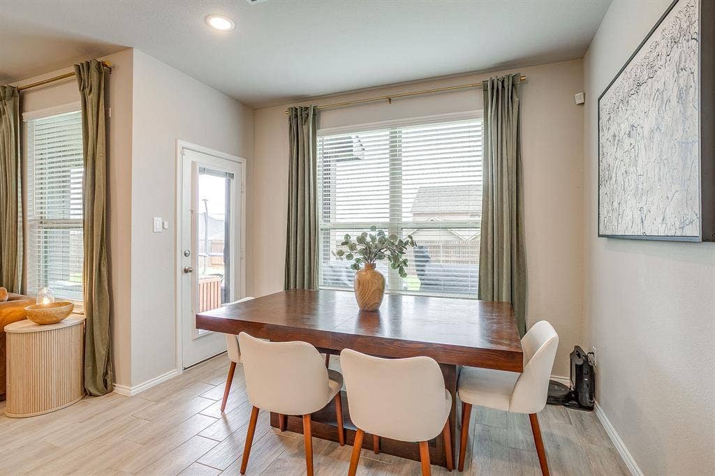 14124 Cassiopeia Drive, Haslet, TX 76052 Dining nook features perfect lighting and windows. Plenty of space for your favorite dining table. Access to back patio.