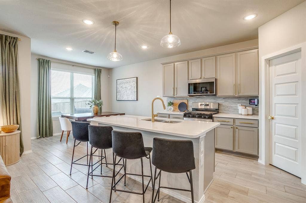 14124 Cassiopeia Drive, Haslet, TX 76052 Upgraded pendant lights over counter height breakfast bar.