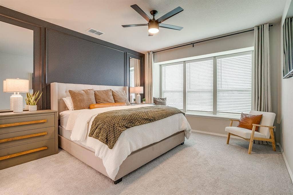 14124 Cassiopeia Drive, Haslet, TX 76052 Primary ensuite is luxurious featuring accent wall, designer ceiling fan and bay window.