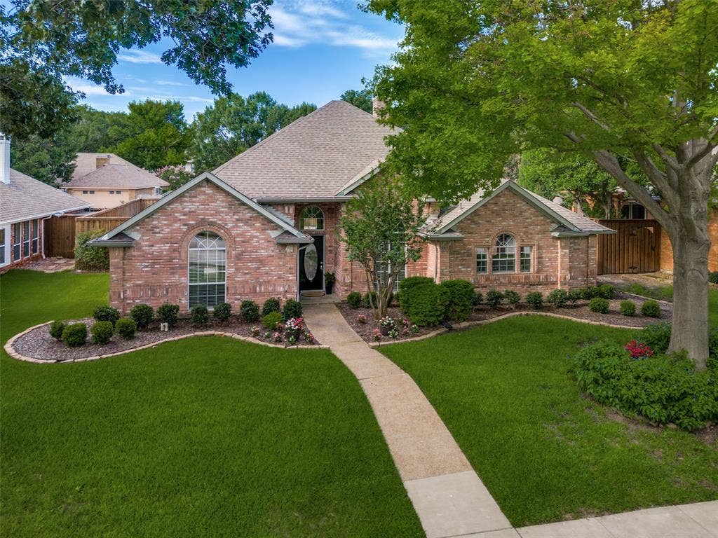 4420 Barwyn Lane, Plano, TX 75093 Brick exterior featuring a gabled roof and arched windows
