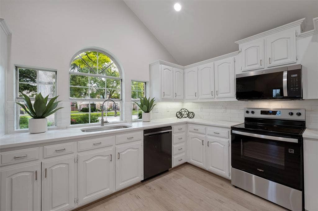 4420 Barwyn Lane, Plano, TX 75093 Kitchen featuring white cabinetry, white countertops, stainless steel appliances, and wood-finish flooring