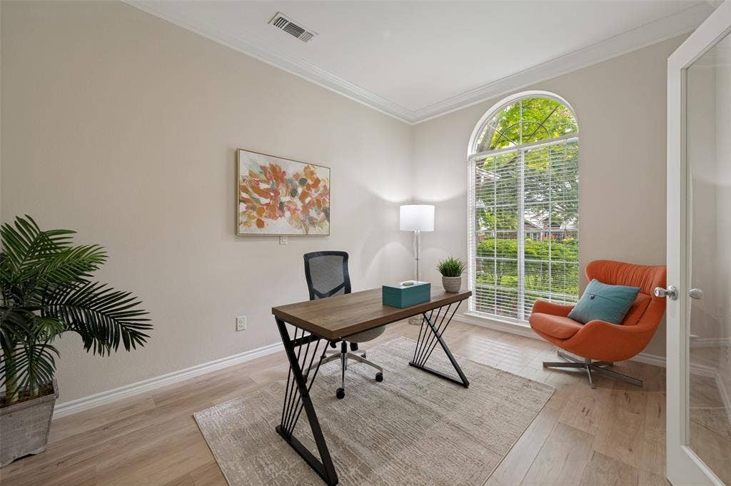 4420 Barwyn Lane, Plano, TX 75093 Room featuring an arched window, crown molding, and wood-finish flooring