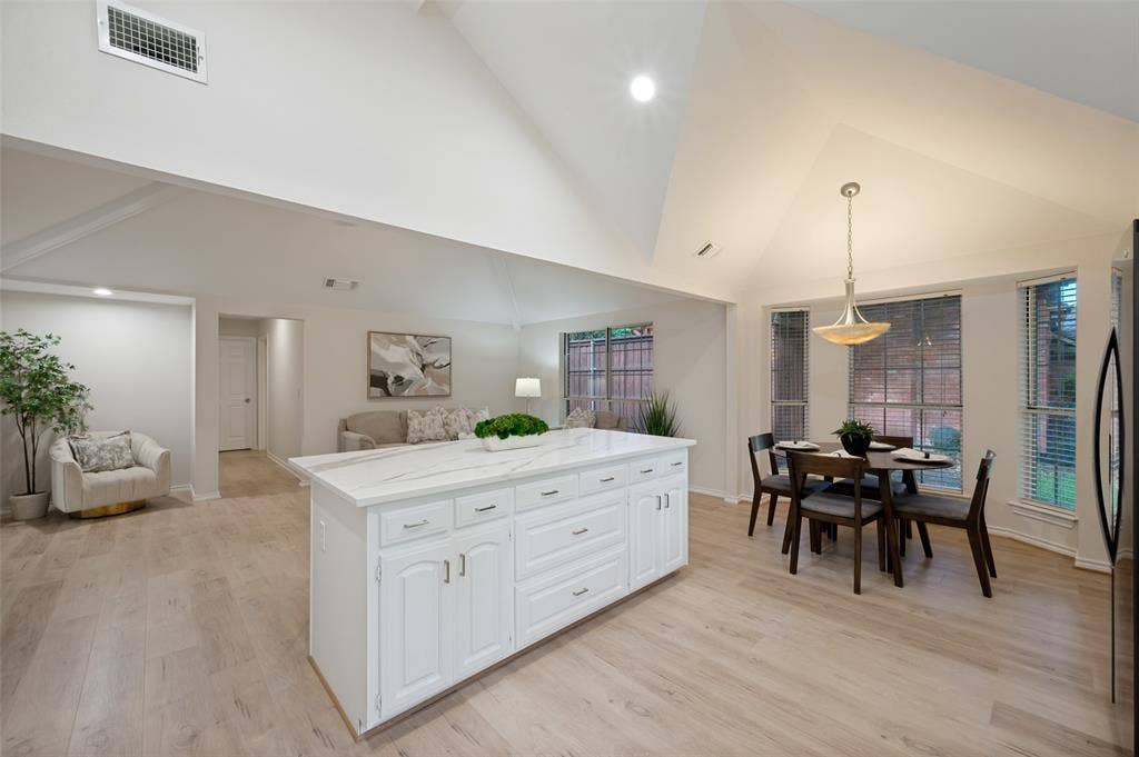 4420 Barwyn Lane, Plano, TX 75093 Open-concept living space featuring vaulted ceilings and wood-finish flooring