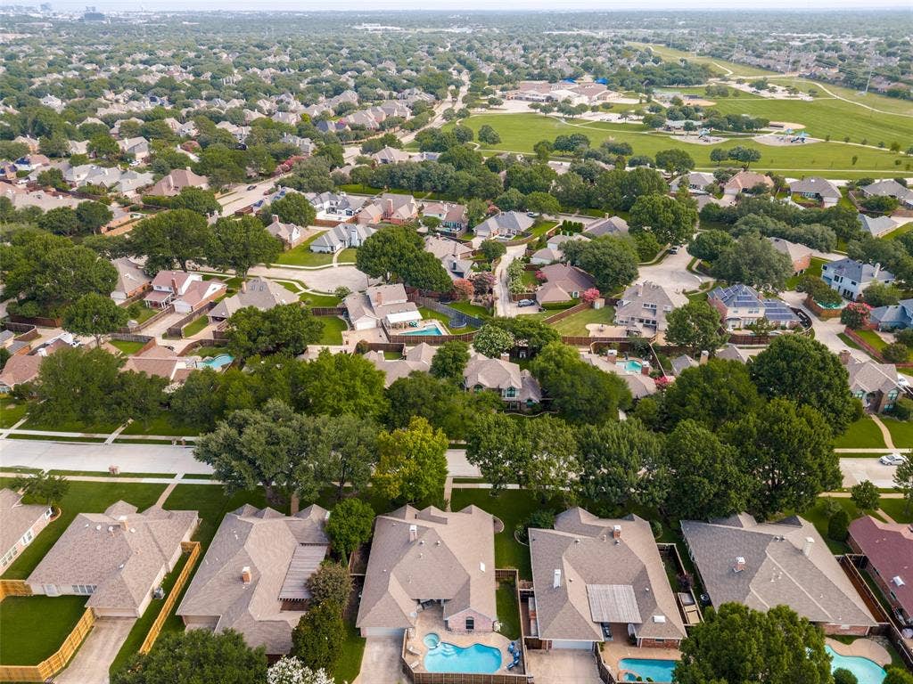 4420 Barwyn Lane, Plano, TX 75093 Aerial perspective showcasing a residential neighborhood with numerous single-story and two-story homes featuring varying rooflines and exterior finishes
