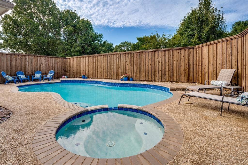 4420 Barwyn Lane, Plano, TX 75093 Private backyard featuring a freeform swimming pool and integrated spa