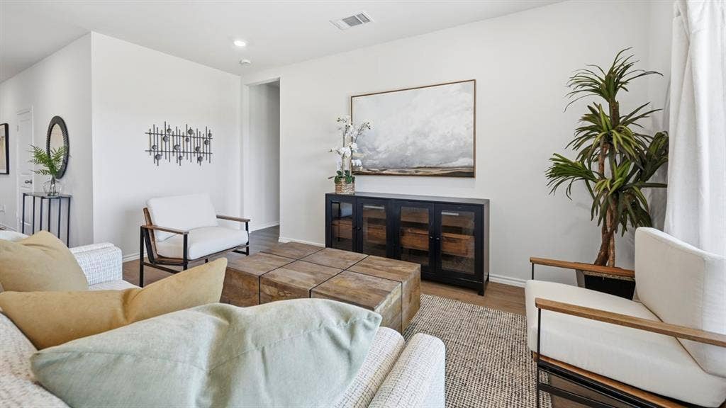 1957 Freeman Street, Tyler, TX 75704 Open-concept living area featuring light-toned wall paint and wood-finish flooring