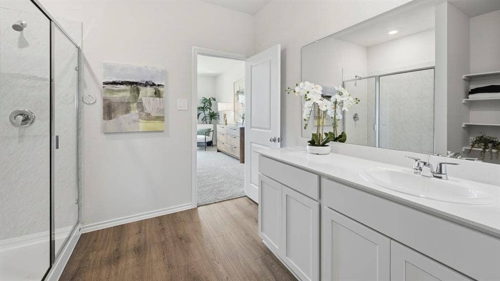 1957 Freeman Street, Tyler, TX 75704 Spacious bathroom featuring a white vanity with an integrated sink, a large wall-mounted mirror, and a glass-enclosed shower