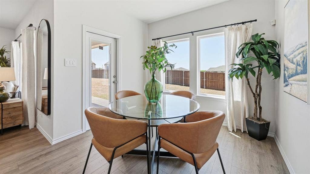 1957 Freeman Street, Tyler, TX 75704 Bright dining area featuring wood-finish flooring, white walls, and a glass-paneled back door