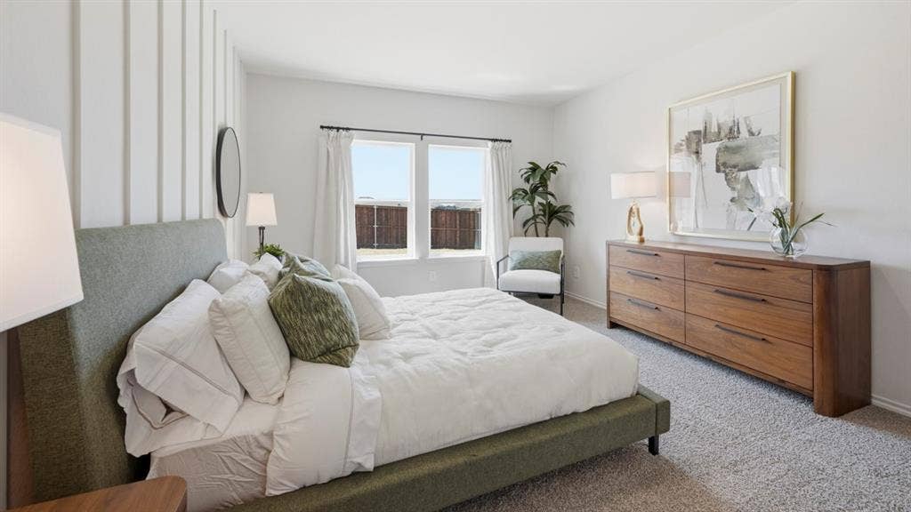 1957 Freeman Street, Tyler, TX 75704 Spacious bedroom featuring light gray carpeting, crisp white walls, a prominent accent wall with vertical paneling, and a large window with white curtain panels