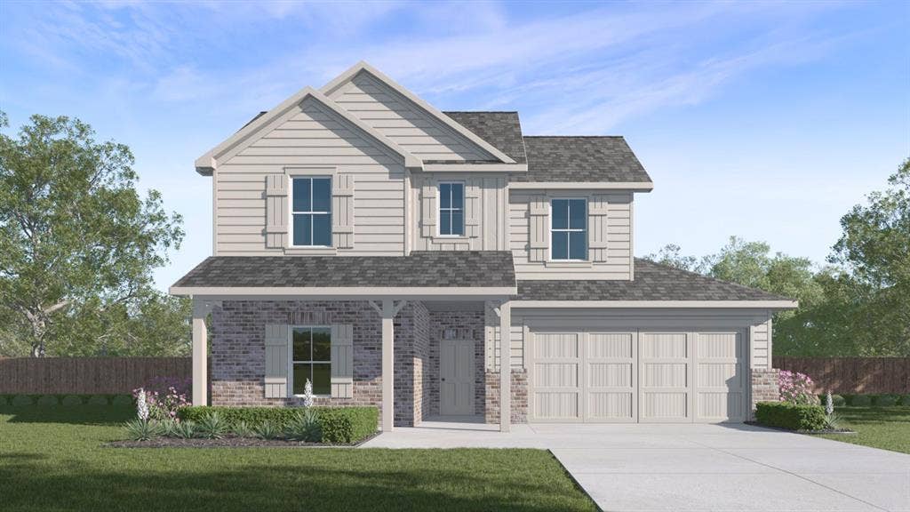 1957 Freeman Street, Tyler, TX 75704 Two-story exterior featuring a covered front porch, a two-car garage, and a combination of brick and siding finishes