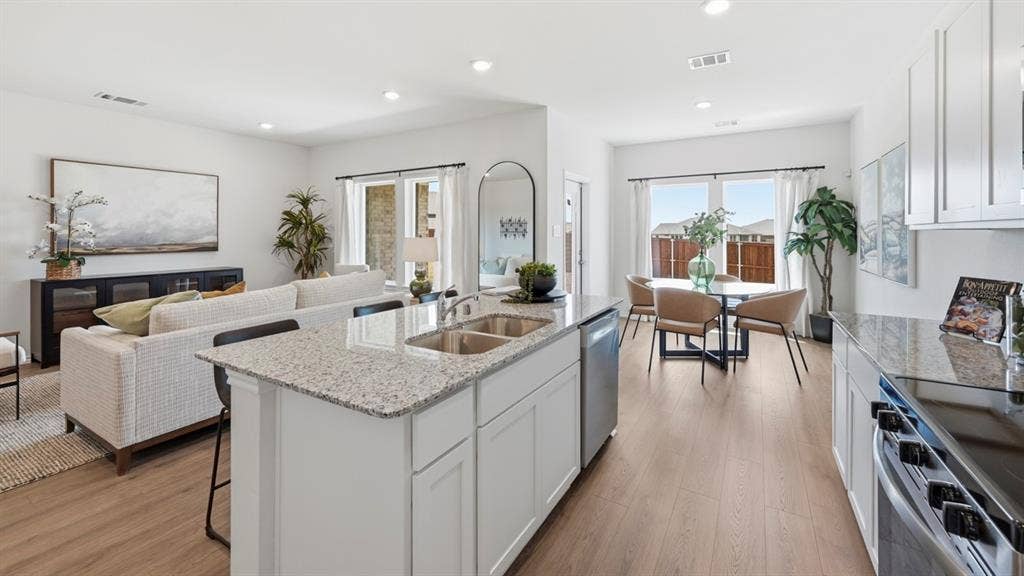 1957 Freeman Street, Tyler, TX 75704 Open-concept living space featuring wood-finish flooring, recessed lighting, and white walls throughout