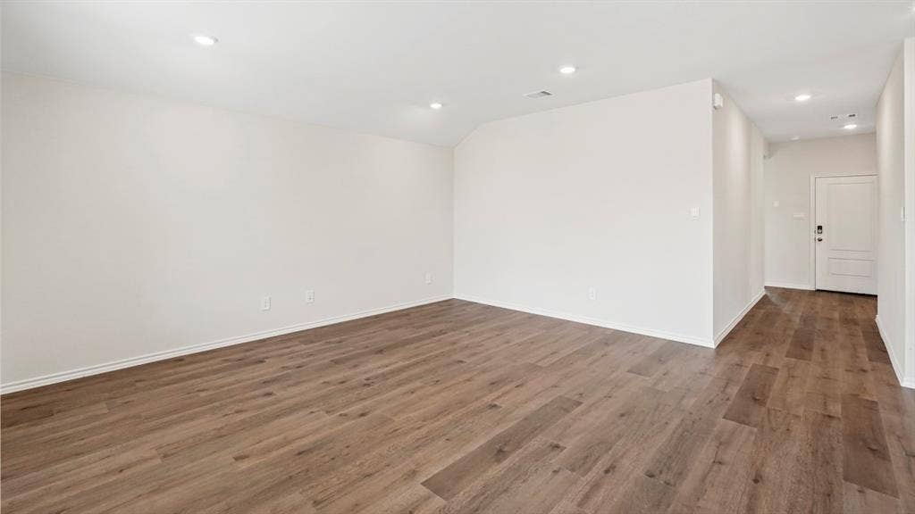 1969 Freeman Street, Tyler, TX 75702 Spacious room featuring wood-finish flooring, recessed lighting, and crisp white walls