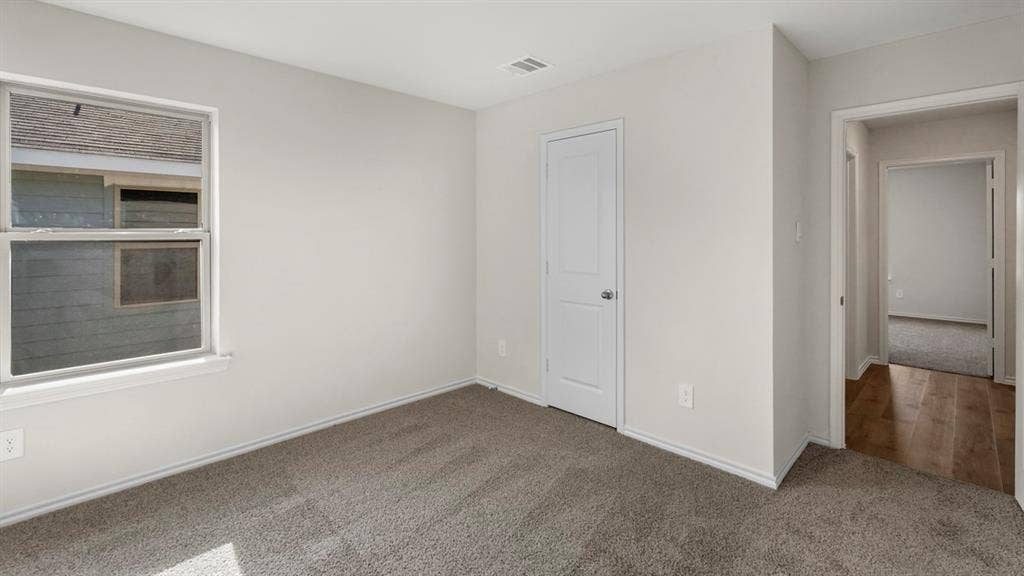 1969 Freeman Street, Tyler, TX 75702 Neutral-toned room with plush carpeting and a double-paned window