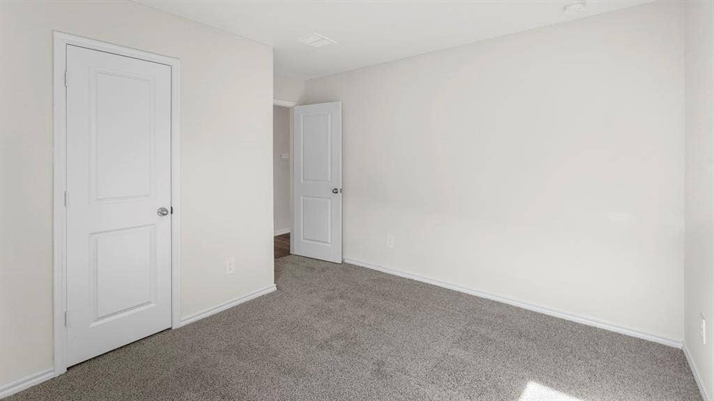 1969 Freeman Street, Tyler, TX 75702 Room featuring light gray carpeting, neutral wall paint, and white trim
