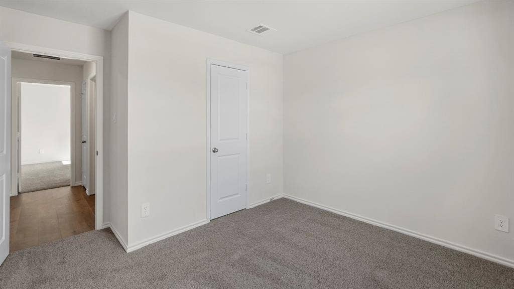 1969 Freeman Street, Tyler, TX 75702 Carpeted room with white walls, baseboards, and trim