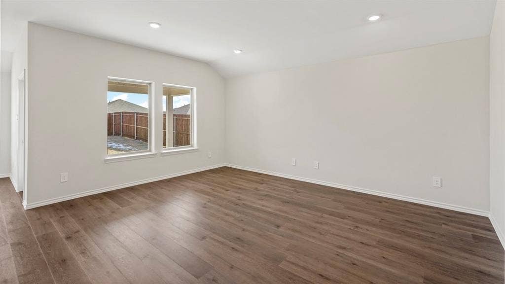 1969 Freeman Street, Tyler, TX 75702 Spacious room featuring wood-finish flooring, white baseboards, and neutral wall paint