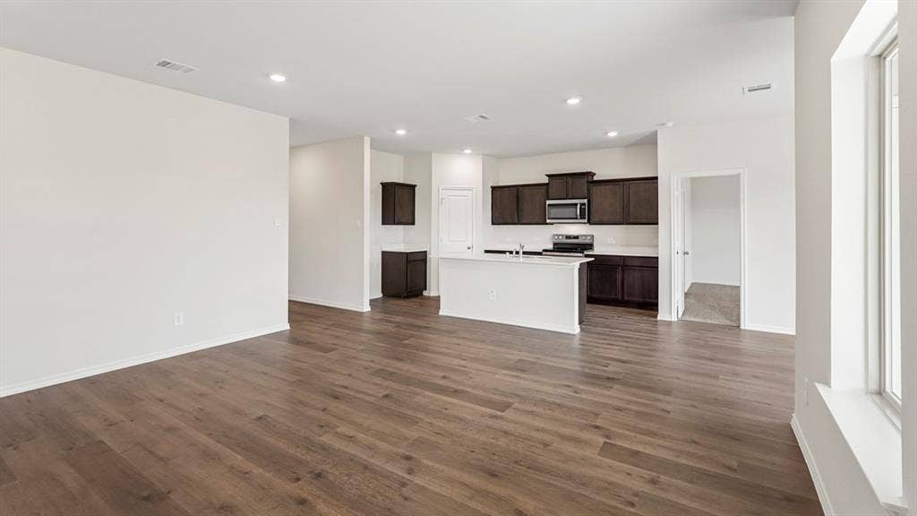 1969 Freeman Street, Tyler, TX 75702 Spacious open-concept area featuring wood-finish flooring, recessed lighting, and a kitchen island