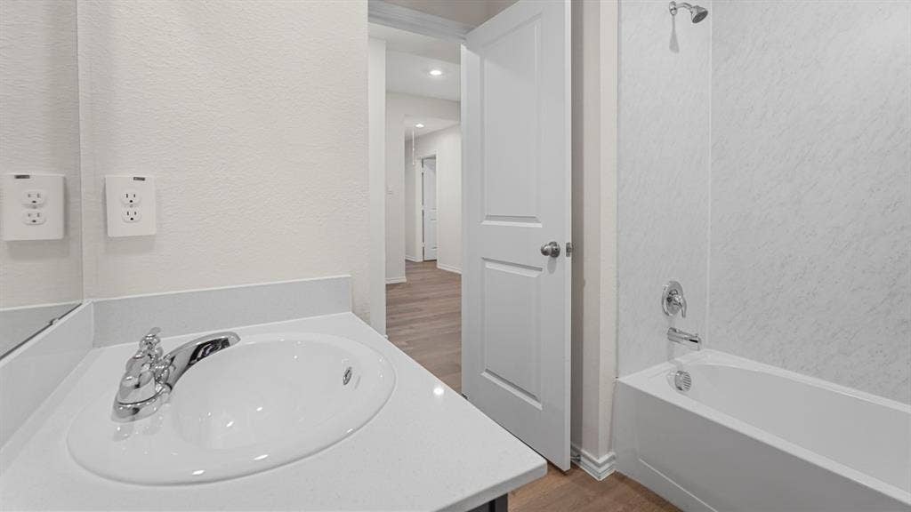 1969 Freeman Street, Tyler, TX 75702 Bathroom featuring a built-in vanity with an integrated sink, polished chrome faucet, and white countertop