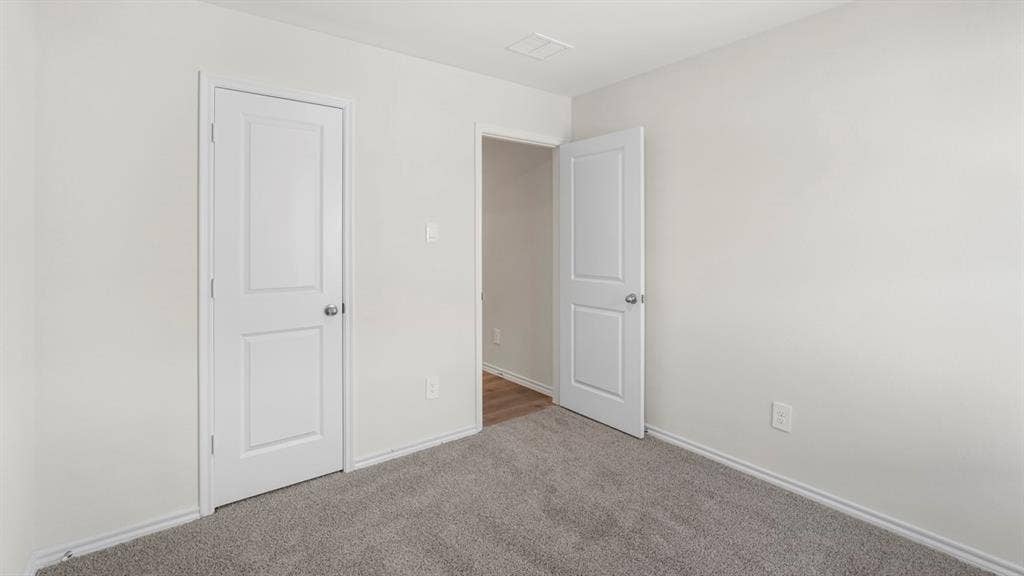 1969 Freeman Street, Tyler, TX 75702 Neutral painted walls with white trim, gray carpet flooring, and white two-panel doors