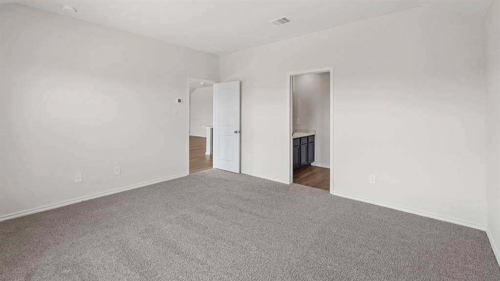 1969 Freeman Street, Tyler, TX 75702 Spacious room with light gray carpeting, neutral wall paint, and white trim