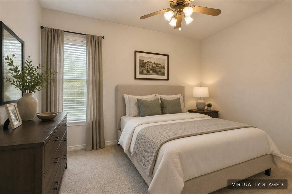 Neutral wall paint, ceiling fan with integrated lighting, window with blinds, and carpeted flooring