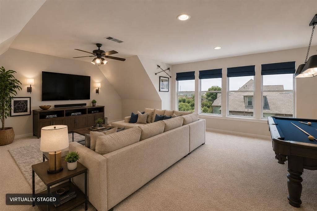 Spacious room with sloped ceilings, recessed lighting, and carpet flooring