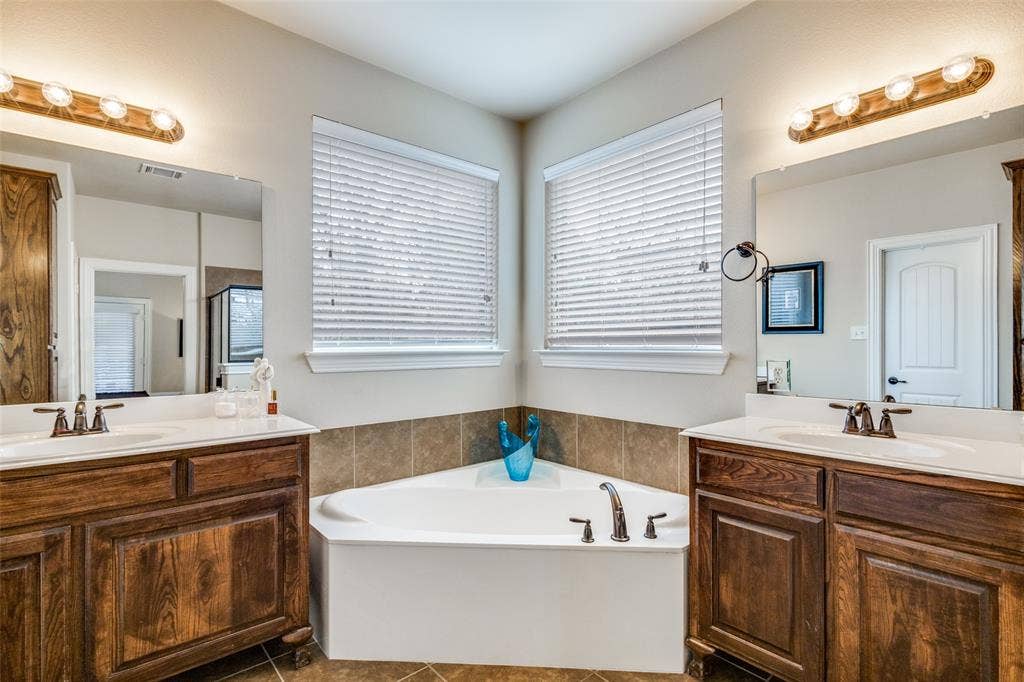 817 Deer Ridge Trail, McKinney, TX 75072 Big Sooaking tub and his and hers vanities and addition storage cabent on other wall