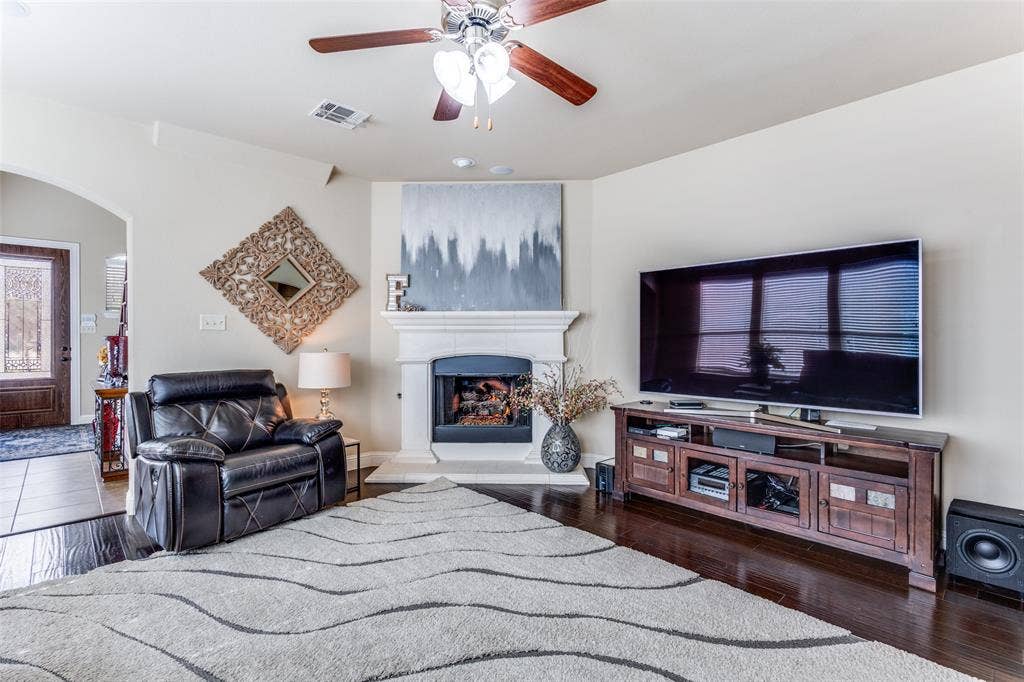 817 Deer Ridge Trail, McKinney, TX 75072 Family Room with wood flooring wall of windows and gas fireplace
