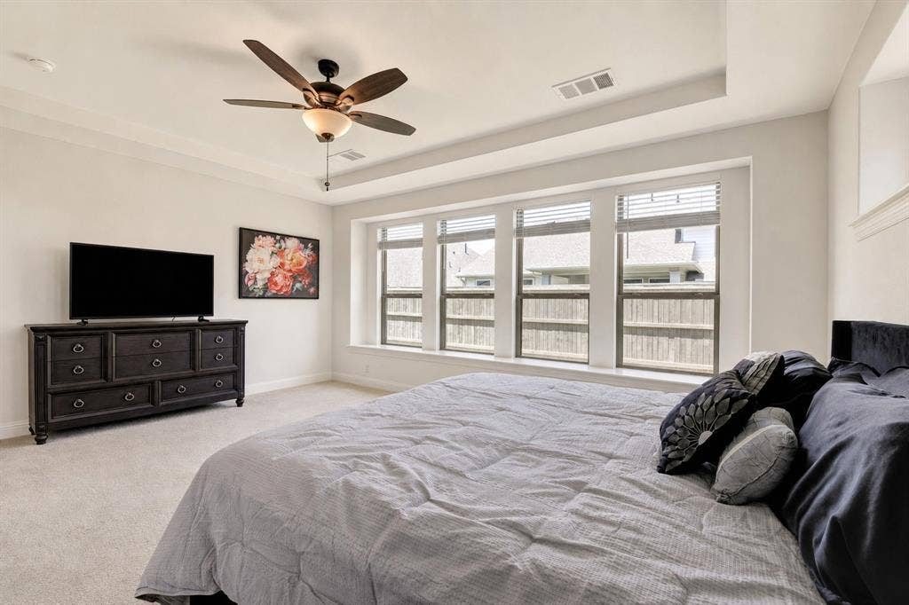 304 Cottontail Lane, Northlake, TX 76247 The spacious first-floor owner's suite includes a sitting area with backyard views.