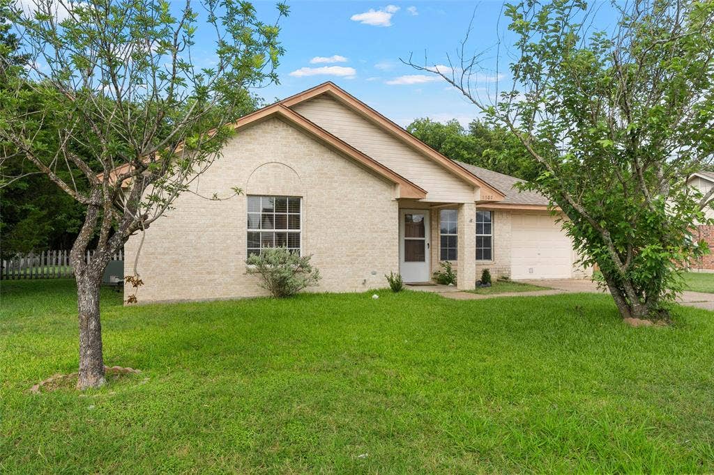 1307 Luanne, Bellmead, TX 76705 Light-colored brick exterior with a front entry, covered porch, and an attached garage