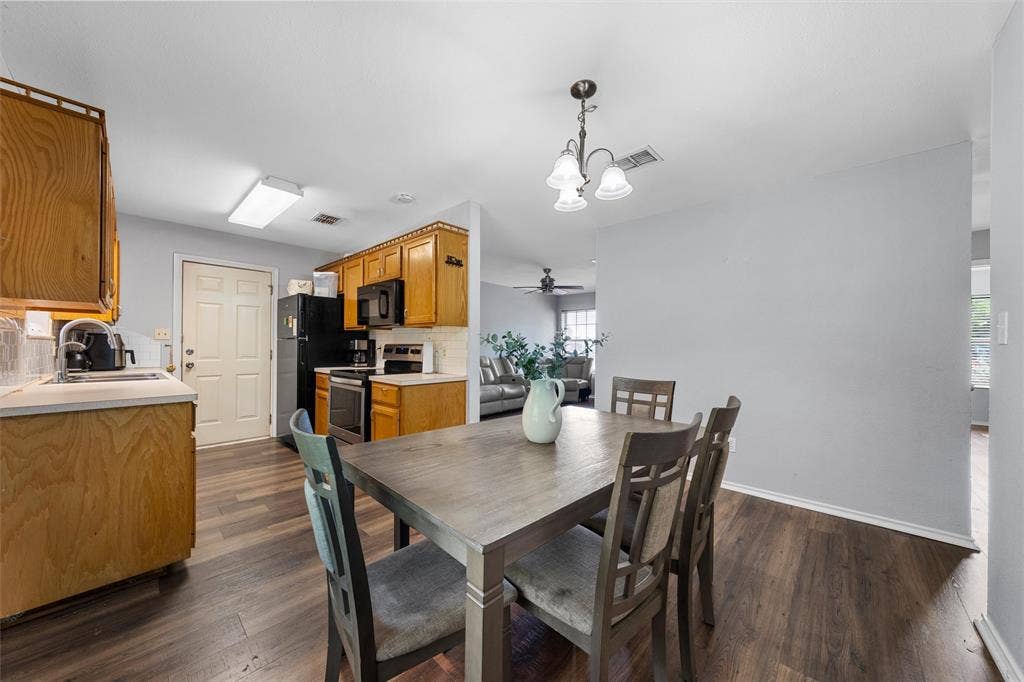 1307 Luanne, Bellmead, TX 76705 Dining area featuring wood-finish flooring and a decorative chandelier