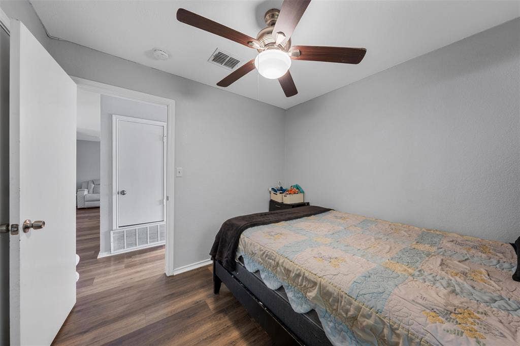 1307 Luanne, Bellmead, TX 76705 Room featuring wood-finish flooring, light gray walls, a ceiling fan with integrated lighting, and white trim