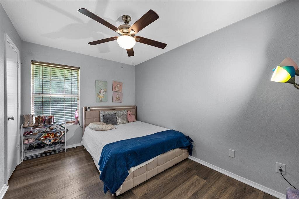 1307 Luanne, Bellmead, TX 76705 Interior room featuring wood-finish flooring, a ceiling fan with integrated lighting, and a window with blinds