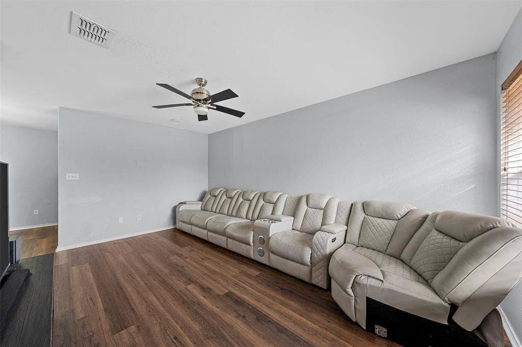 1307 Luanne, Bellmead, TX 76705 Spacious room featuring wood-finish flooring, light gray walls, and a ceiling fan with brushed nickel accents