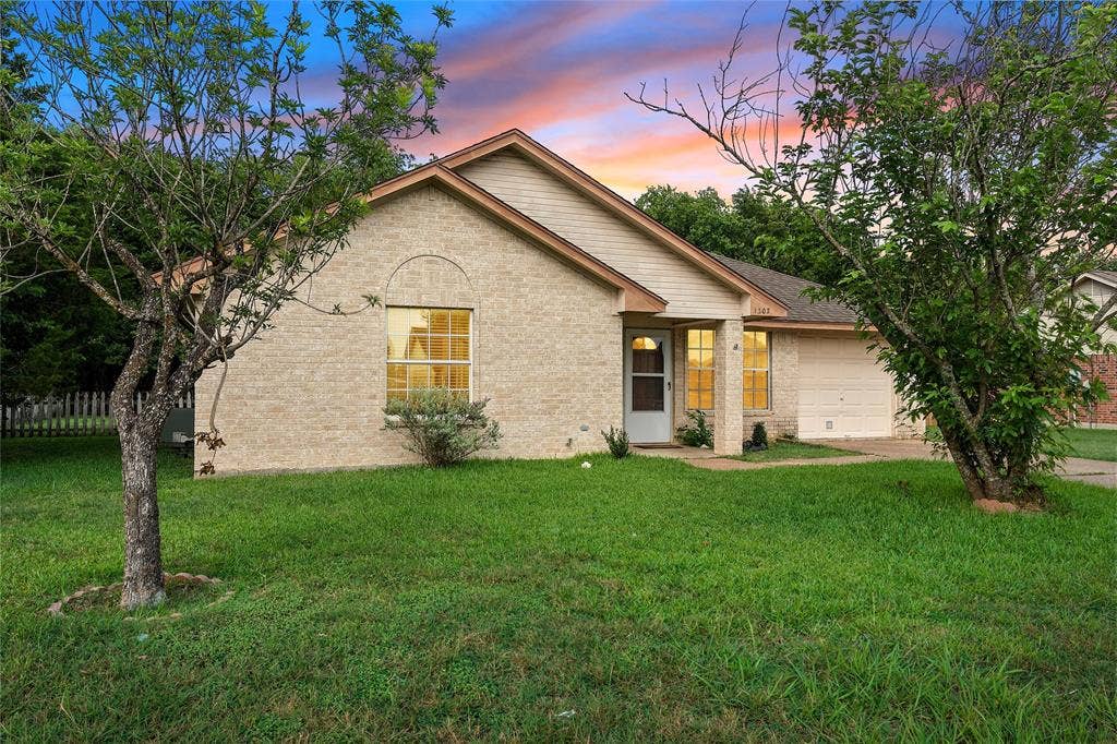 1307 Luanne, Bellmead, TX 76705 Brick exterior with arched window detail, covered entry porch, and attached garage