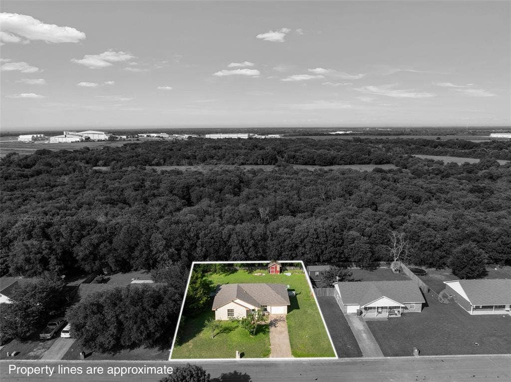 1307 Luanne, Bellmead, TX 76705 Single-story residence with an attached garage, featuring a paved driveway and a manicured front lawn