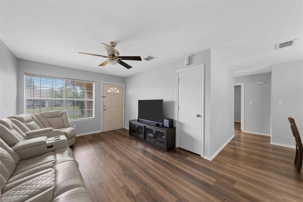 1307 Luanne, Bellmead, TX 76705 Living area featuring wood-finish flooring, a ceiling fan with light fixture, light gray wall paint, and white trim