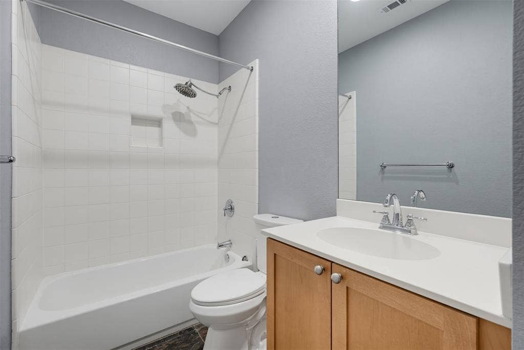 4830 Cedar Springs Road, #30, Dallas, TX 75219 Full bathroom featuring a single vanity with wood-finish cabinetry and a light-toned countertop